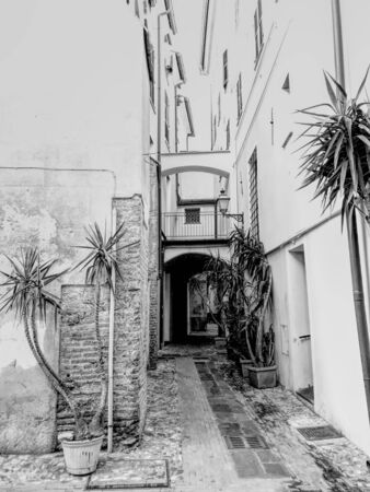 A traditional alley in Albenga, Italy. Black and white.の写真素材