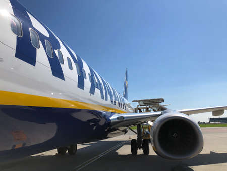 an airplane of the company Ryanair on the runway at the airport in a sunny day with blue skyのeditorial素材