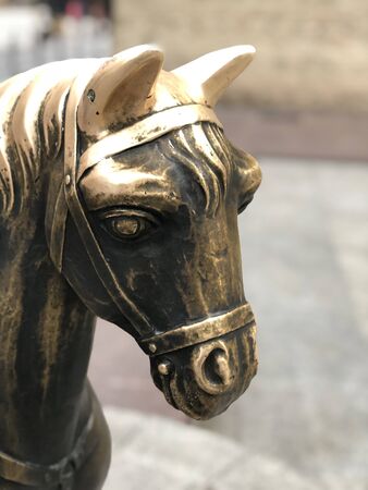 A golden metal horse. Close up.