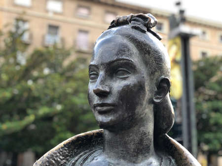 Close up of a statue face of a Spanish young woman in dark stoneのeditorial素材