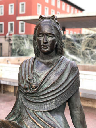 Close up of a statue face of a Spanish young woman in dark stone with traditional dressのeditorial素材