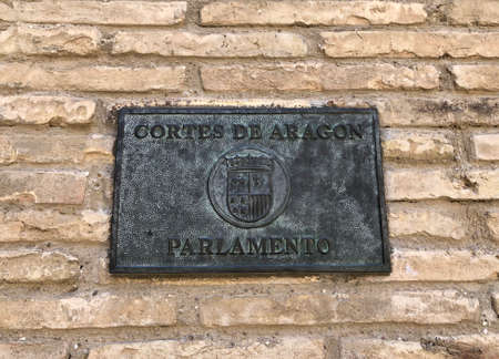 The plaque of the Aragon Parliament in Zaragoza, Spain, on a stone wallのeditorial素材