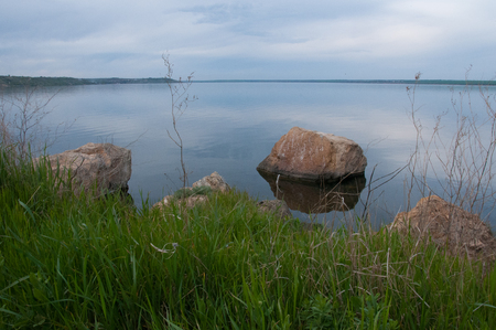 Coast with rocks in the water, Hadzhibey estuary. Reflection in waterの写真素材