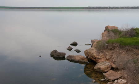 Coast with rocks in the water, Hadzhibey estuary. Reflection in waterの写真素材