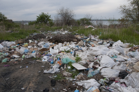 A garbage dump on the shore of the estuary, pollution of the environment, an environmental problem of garbageの写真素材