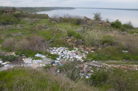 A garbage dump on the shore of the estuary, pollution of the environment, an environmental problem of garbageの写真素材