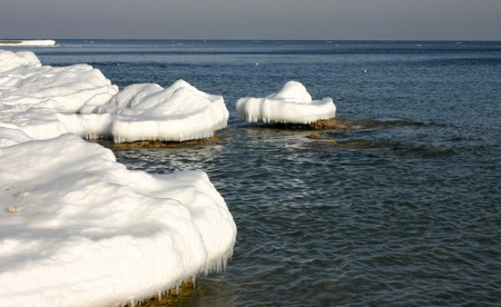 Frozen sea in the Gulf of Odessa Black Sea ice on coastal rocksの写真素材