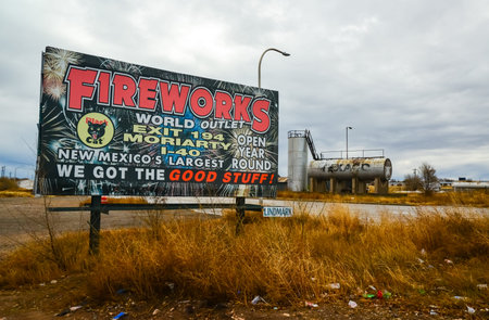 NEW MEXICO, USA - NOVEMBER 20, 2019: advertising sign and old iron barrel for petroleum products on the side of a road in New Mexicoのeditorial素材