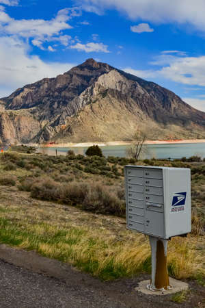 USA, MONTANA - APRIL 28, 2018: letterbox on the side of a road on the shore of a mountain lake in a valley among the mountains in Montana, USAのeditorial素材