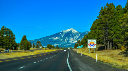 ARIZONA, USA - NOVEMBER 25, 2019: two-lane road with cars, picturesque mountains with snow caps on the horizon in Arizonaのeditorial素材