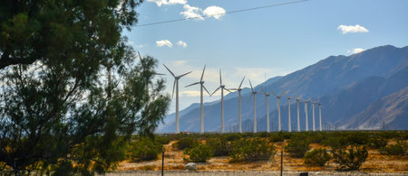 View of wind turbines generating electricity. Huge array of gigantic wind turbines spreading over...