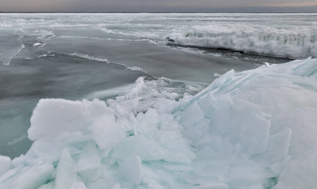 Coastal cliffs and coastal protection structures frozen with ice in the cold winter of 2010, the...