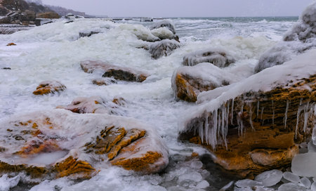Frozen Black Sea, ice-covered and frozen coastal rocks in the piers, harsh winterの写真素材