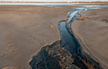 Salt water with black mud flows from the Kuyalnik sanatorium to the Kuyalnik estuary