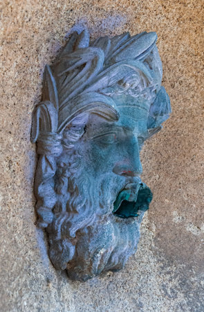 NANTES, FRANCE - SEPTEMBER 12, 2017: granite head with a mouth drain for rainwater on a wall in Nantes, Franceのeditorial素材
