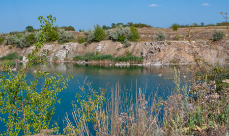 View of the flooded granite quarry with turquoise clear water, Ukraineの写真素材