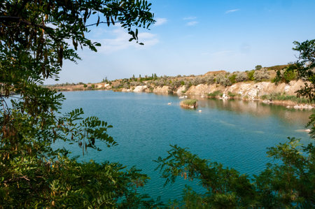 View of the flooded granite quarry with turquoise clear water, Ukraine