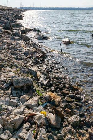 Plastic garbage and microplastics on the shore of Khadzhibey Estuary, environmental problem of the reservoir, nature pollutionの写真素材