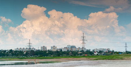 Fluffy white rain clouds over the city near Kuyalnik estuary, south of Ukraineの写真素材