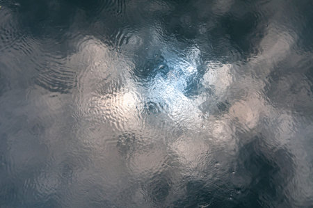 Reflection of clouds and sun in water in the Southern Bug River, Ukraine