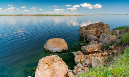 Natural landscape, shell stones in the water near the shore of the Khadzhibey estuary, southern Ukraineの写真素材