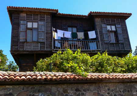 BULGARIA, SOZOPOL - AUGUST 26, 2014: Clothes are dried on an old wooden house with an original shore exterior near Sozopol, Bulgariaのeditorial素材