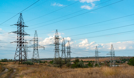 UKRAINE, ODESSA - SEPTEMBER 19, 2021: High-voltage lines on steel structures with wires against the background of the sky with clouds, Ukraineのeditorial素材