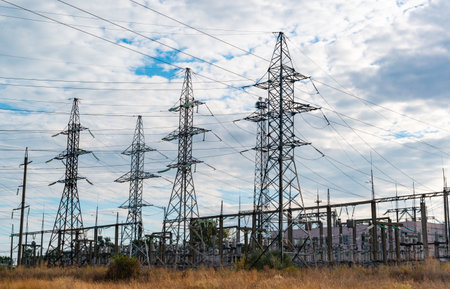 UKRAINE, ODESSA - SEPTEMBER 19, 2021: High-voltage lines on steel structures with wires against the background of the sky with clouds, Ukraineのeditorial素材