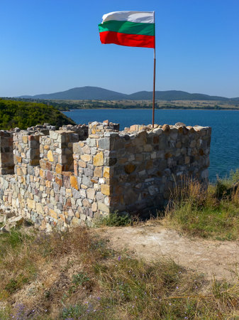 BULGARIA, KALIAKRA - AUGUST 26, 2014: Bulgarian flag on the ruins of ancient buildings on Cape Kaliakra, Bulgariaのeditorial素材