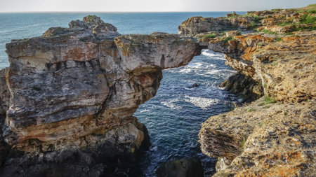 Large arch in coastal rocks made of shell rock near the village of Tyulenovo, southern Bulgariaの写真素材