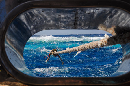 Mooring with a thick rope to the island of a diving yacht during a storm, Red Seaの写真素材