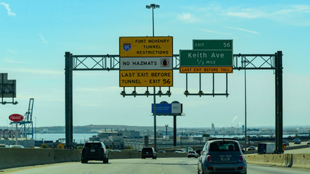 Maryland, USA - November 02, 2025: This image shows highway signage for Interstate 95 in Maryland, specifically regarding restrictions for the Fort McHenry Tunnel. Vehicles carrying hazardous materials (HAZMATS) are not permitted to travel through the F