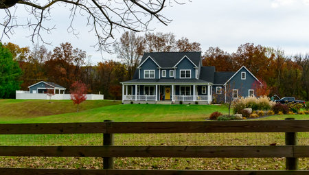 Virginia, USA - November 02, 2025: This is a modern two-story colonial-style home with a dark blue exterior and a large white front porch.