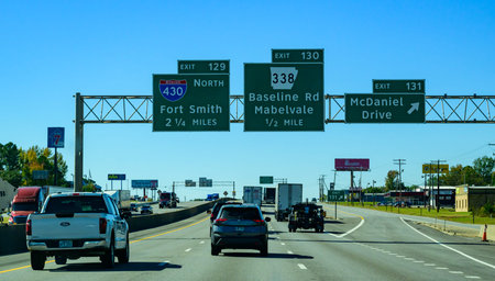 Arkansas, USA - November 04, 2025: This image shows highway traffic signs in Little Rock, Arkansas, specifically approaching the interchange for Interstate 430 and Exit 130. The blue Interstate 430 sign indicates a route towards Fort Smith, Arkansas, whic