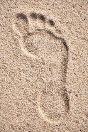 Single footprint on sand beachの写真素材