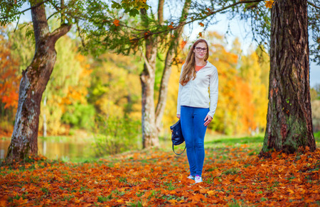 Beautiful woman in autumn parkの写真素材