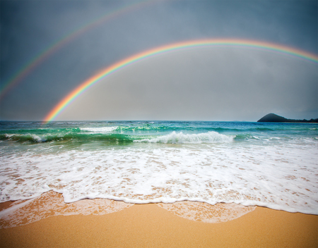 stormy sea and cloudy sky with rainbowの写真素材