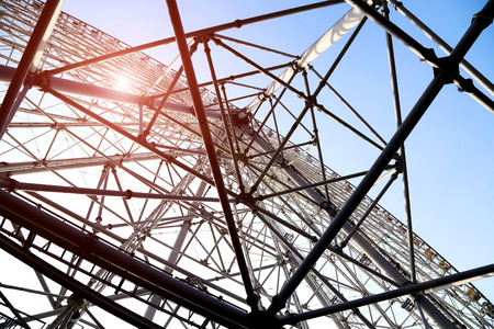 ferris wheel steel structure under the blue skyの写真素材
