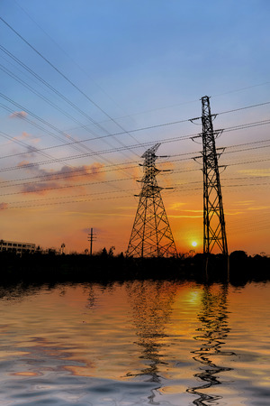 Power towers are reflected in the riverの写真素材