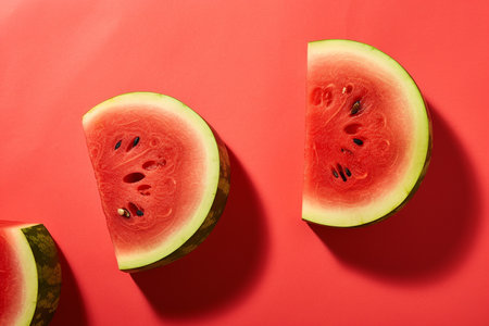 Fresh watermelon slices on a red backgroundの素材