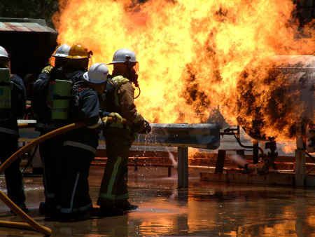 Huge Flames as gas leak catches fire and burns out of control with fire crews trying to dampen flamesの写真素材