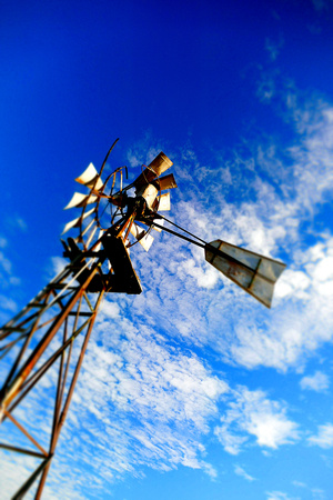 Vintage Windmill Background on rural farming property pumping live stock bore from underground water table in salty, saline drought stricken outback environment with historyの写真素材