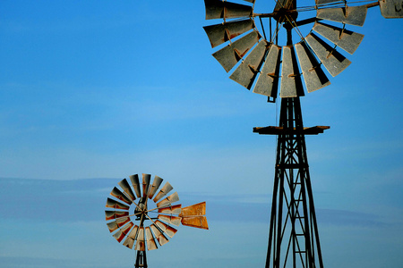 Vintage Windmill Background on rural farming property pumping live stock bore from underground water table in salty, saline drought stricken outback environment with historyの写真素材
