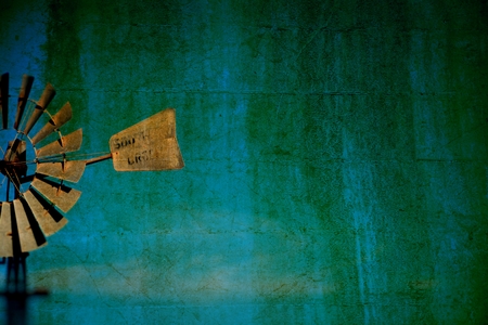 Vintage Windmill Background on rural farming property pumping live stock bore from underground water table in salty, saline drought stricken outback environment with historyの写真素材