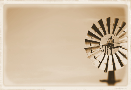 Vintage Windmill Background on rural farming property pumping live stock bore from underground water table in salty, saline drought stricken outback environment with historyの写真素材