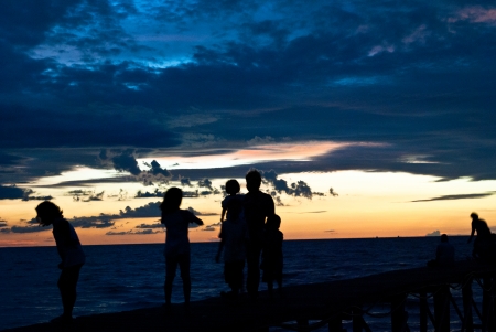 Wooden Jetty on sunset with some people silouetteの写真素材