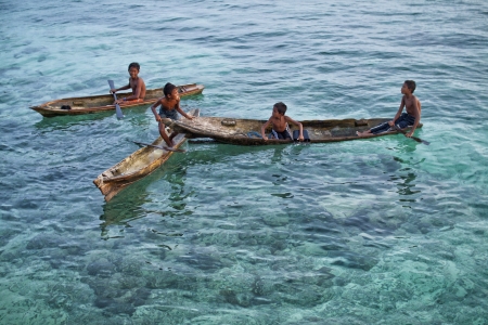 MABUL ISLAND, Sabah  Local sea kids playing around at crystal clear water at Mabul Islandのeditorial素材