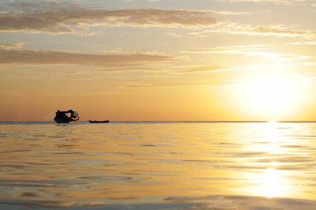 boat silhouette with beautiful sunset on the backgroundの写真素材