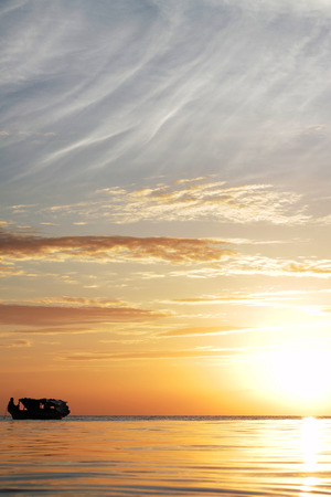 boat silhouette with beautiful sunset on the backgroundの写真素材