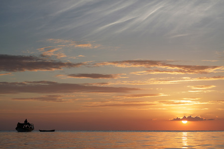 boat silhouette with beautiful sunset on the backgroundの写真素材